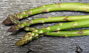 Showing Local Asparagus on Black Textured Tile