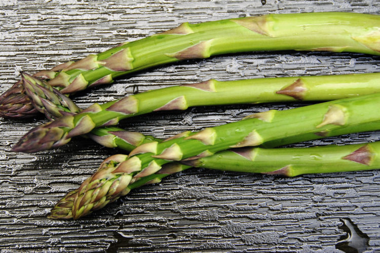 Showing Local Asparagus on Black Textured Tile